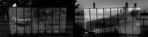 scroling text reads Community Is...  across a two-sided free-standing large LED screen on a city river bank with people jogging and cycling by