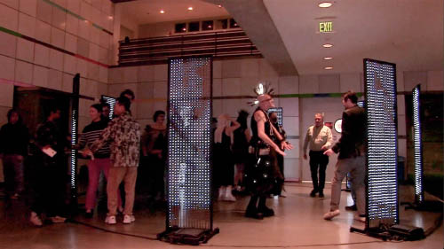 8 handmade LED video panels in a circle with people dancing amongst them